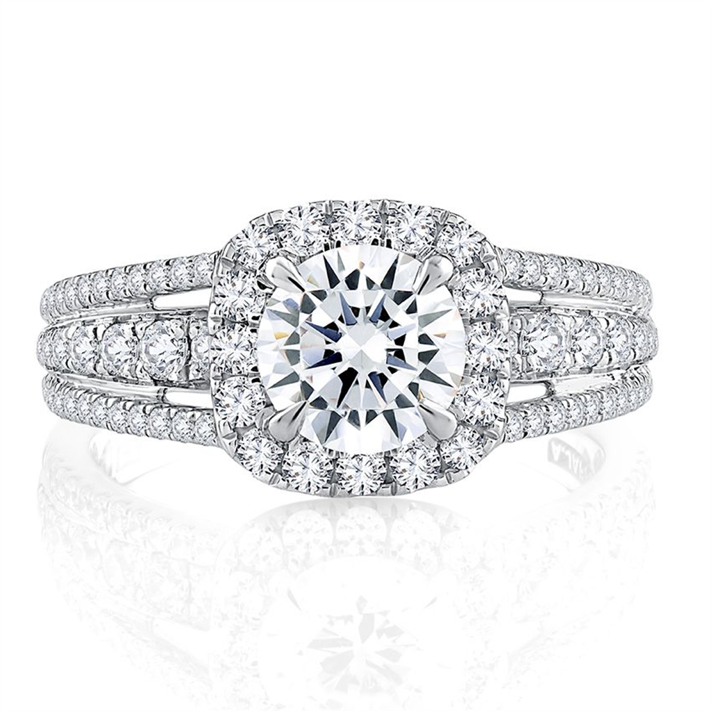 A white gold engagement ring with a halo and diamonds.