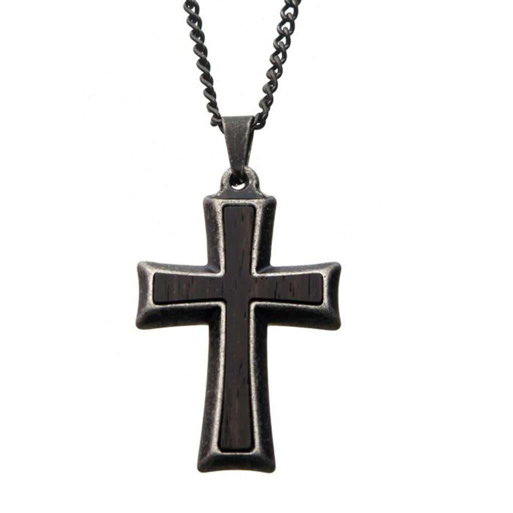 A black cross pendant on a chain.