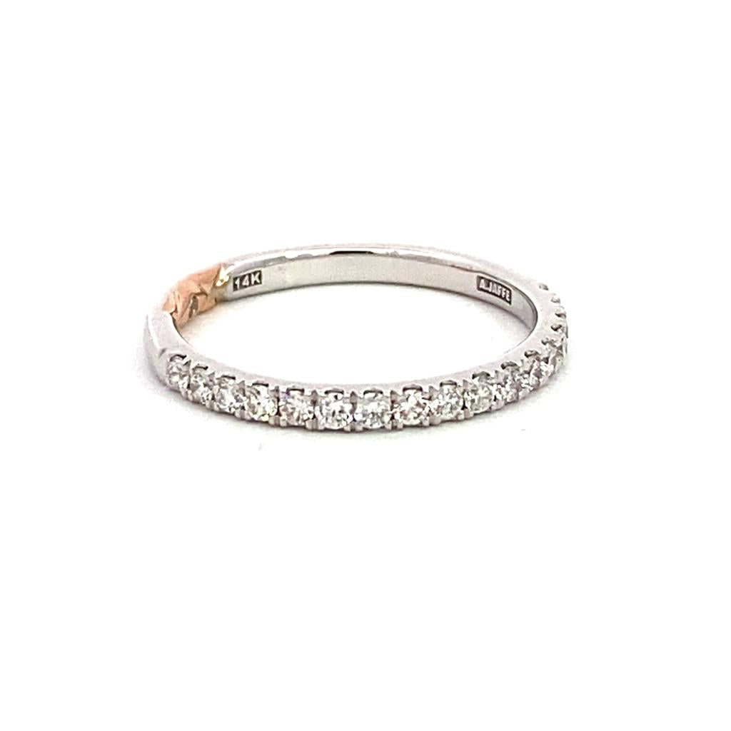 A white gold band with diamonds on it.