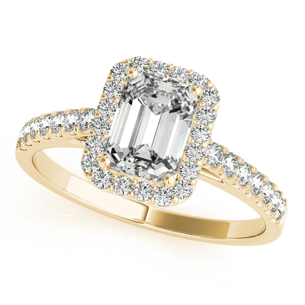 An emerald cut diamond halo engagement ring in yellow gold.