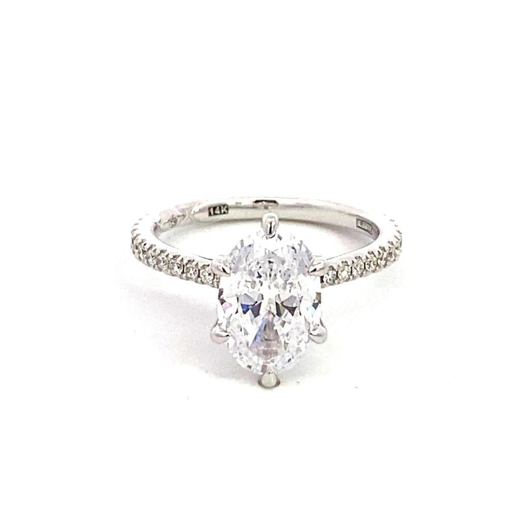 A white gold ring with an oval cut diamond.