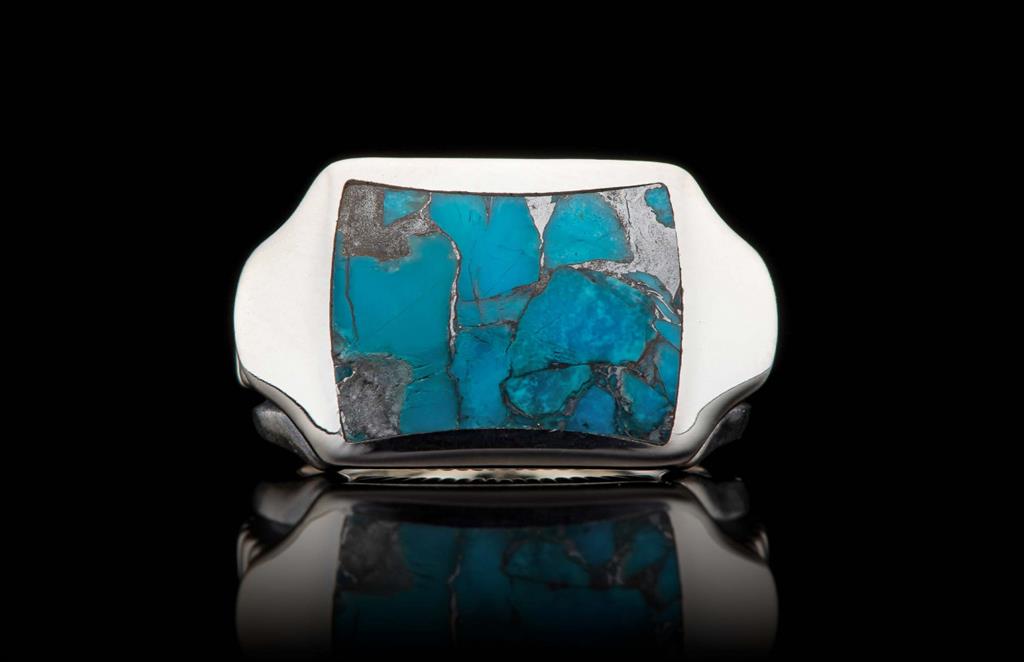 A silver ring with a turquoise stone.
