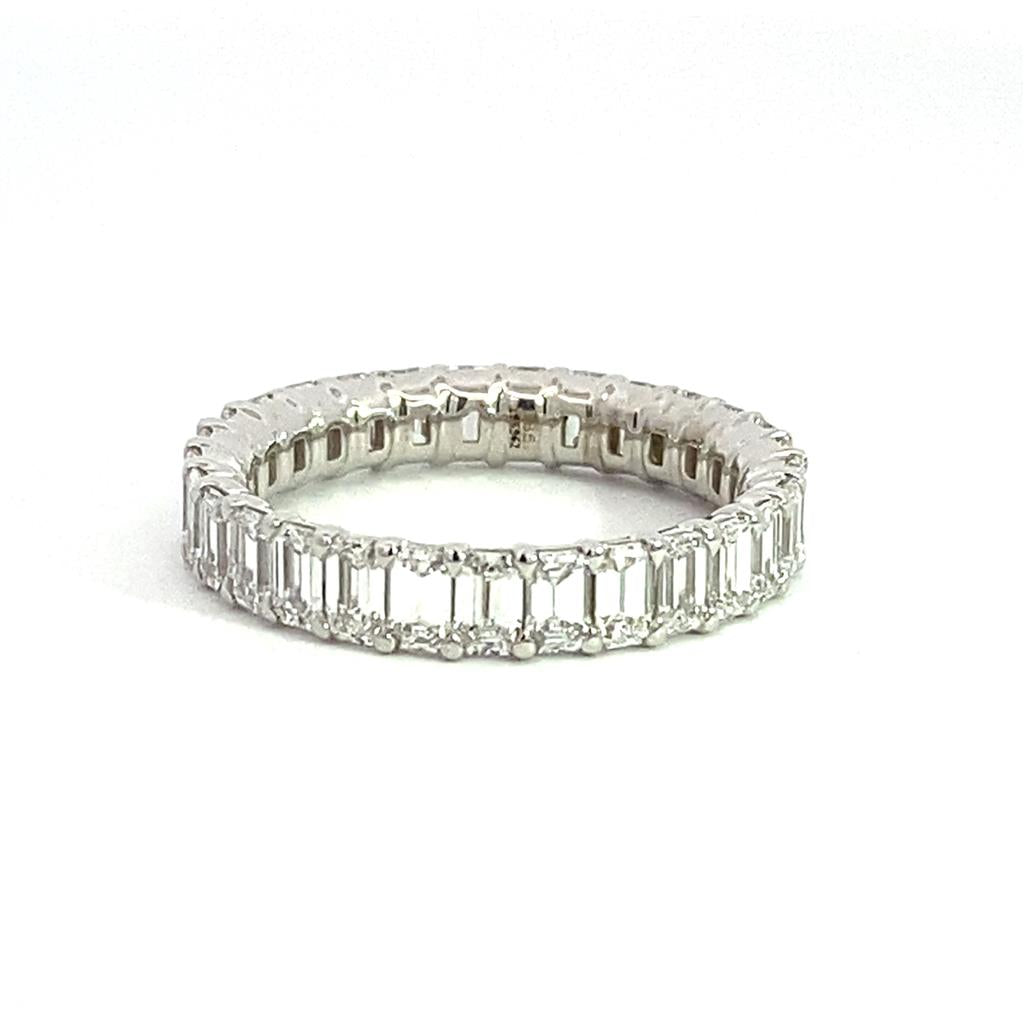 A white gold eternity band with baguette cut diamonds.