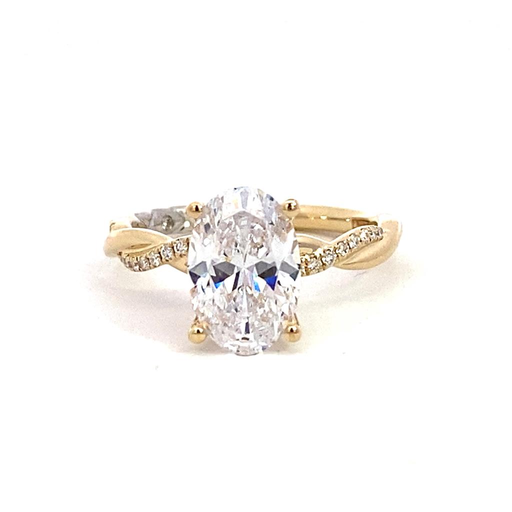 An oval cut diamond ring set in yellow gold.